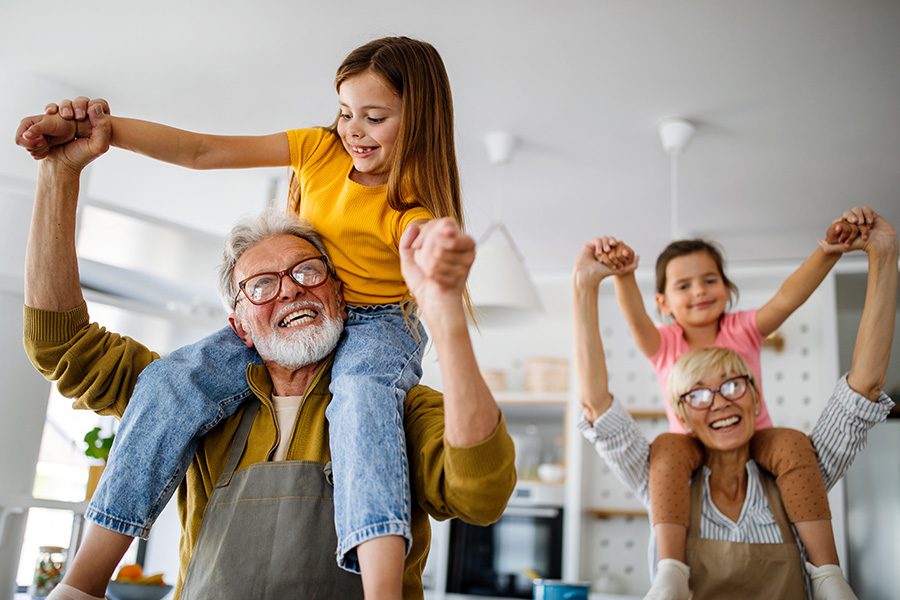 About Our Agency - Grandchildren Having Fun at Home While Playing With Their Grandparents